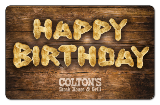 Happy Birthday written with shelled peanuts over a wooden background with the Coltons logo in white.